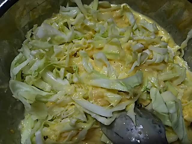 add the cabbage to the bowl and stir